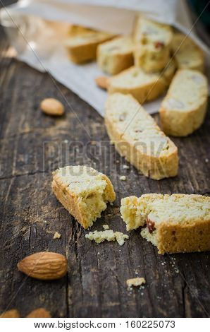 Italian cantuccini cookies with almond. Traditional italian almond cookies biscotti on old wooden background. Homemade Almond cookies on wooden table. Delicious cookies biscotti. Selective focus.