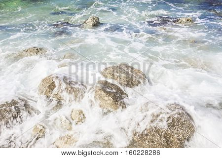 Waves on rocks in sunny day Portonovo Italy