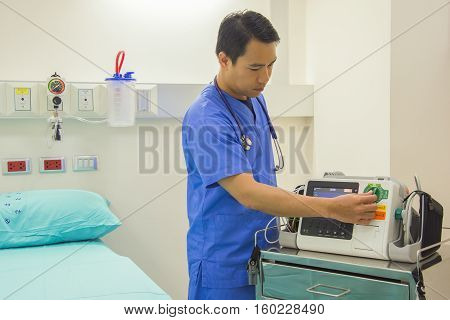 male doctor and stethoscope stap on the neck use EKG monitor in medicla room