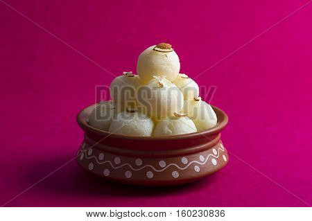 Indian Sweet or Dessert - Rasgulla, Famous Bengali sweet in clay bowl
