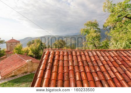 Tiled roofs of ancient Orthodox monastery in Alazani valley, Georgia. Nekresi monastery was erected in 4th - 7th century