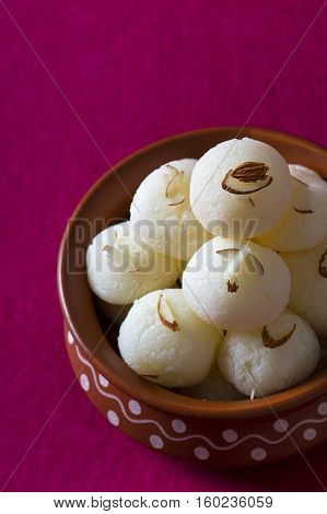 Indian Sweet or Dessert - Rasgulla, Famous Bengali sweet in clay bowl