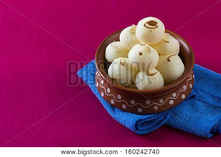 Indian Sweet or Dessert - Rasgulla, Famous Bengali sweet in clay bowl with napkin