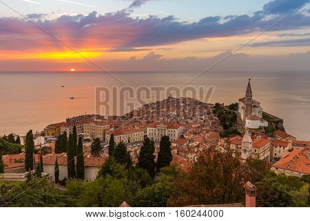 Romantic colorful sunset over picturesque old costal town Piran, Slovenia. Senic panoramic view.