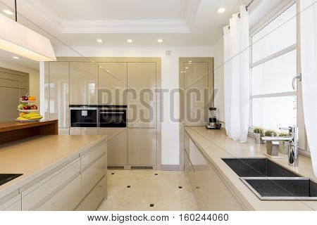 Kitchen With Bright Furnitures And Sink