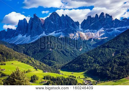 Odle mountain peaks surround the green alpine meadows of the valley. Dolomites, Val de Funes valley. Lovely sunny day in  Nature Park Puez-Odle