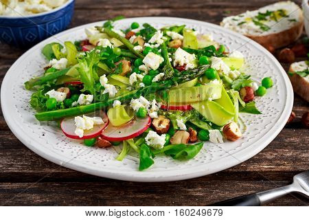 Fresh Green Asparagus salad witch Goat Cheese, peas, radishe, zucchini, lettuce and Hazelnuts