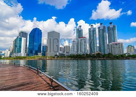 Cityscape image of Benchakitti Park at blue sky background in Bangkok Thailand.