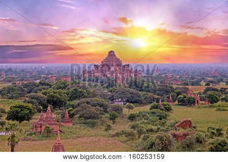 Ancient pagodas in the landscape from Bagan in Myanmar at sunrise
In the middle the Dhammayangyi Temple, The biggest of all temple in Bagan. 