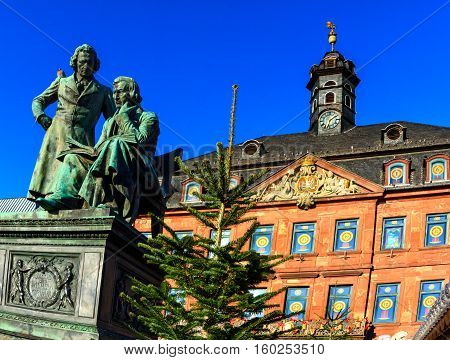 Brothers Grimm in front of the town hall in Hanau looking down at the Christmas market, Germany