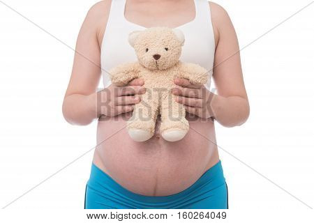The belly asia pregnant woman holdind a teddy bear doll isolate on white background