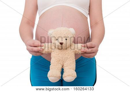 The belly asia pregnant woman holdind a teddy bear doll isolate on white background