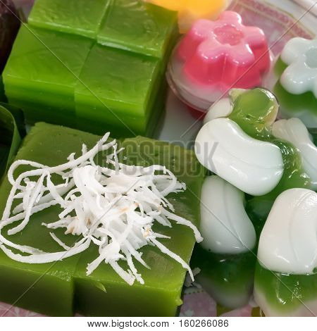 The group of Thai sweet dessert : Layer sweet cake (Kanom Chan), Green coconut sweet pudding (Kanom Piak Poon), Coconut milk jelly (Wun Kati).