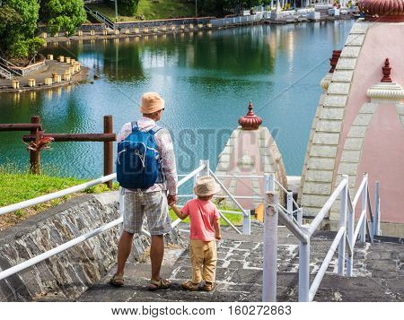 Father and child at Ganga Talao temple. Mauritius. 