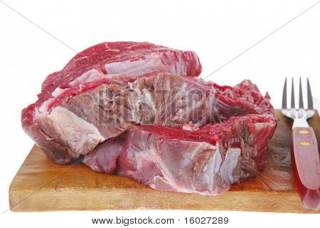 raw fillet mignon on cutting board prepared for roasting
