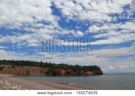 Popular tourist attraction Sea Caves formed from tidal erosion in New Brunswick clay geological structure of coastal line around St. Martins in Bay of Fundy accessible by kayak during high tide.