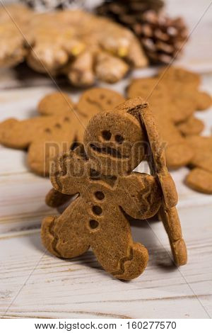 Christmas smiling gingerbread men men and women on rustic wooden background