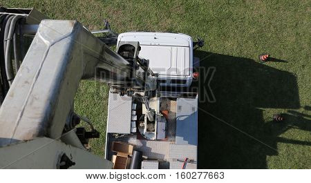 van with a tall ladder truck photographed from the aerial platform
