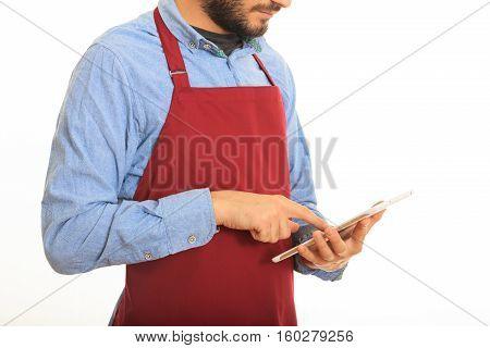 Young Man With Black Apron Taking An Order