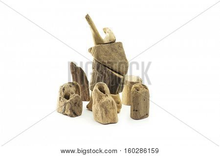 Pieces of drift wood stacked up to look like an deer or reindeer?with surrounding, pieces of drift wood. Isolated on white