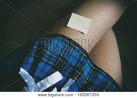 Blue Skirt In The Cell, Sticker On The Leg Of A Word On Paper