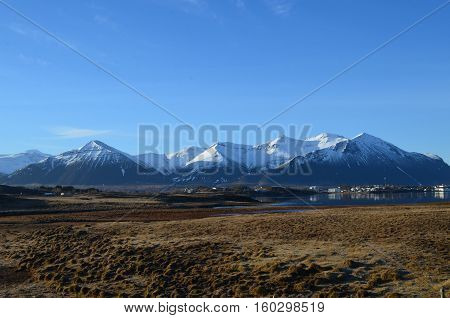 A beautiful view of the snow covered rhyolite mountains in early summer.