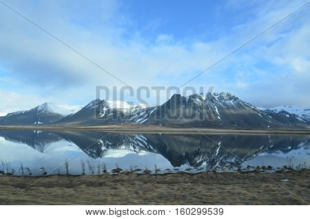 Mirror image of Rhyolite mountains on Snaefellsnes Peninsula in Iceland.