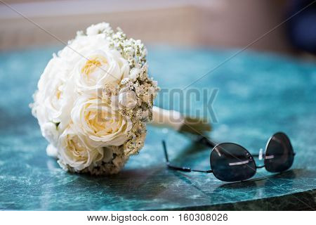 white wedding bouquet laid on the table