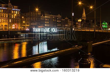 AMSTERDAM - DEC 29, 2015: Artwork by Massimo Uberti & Marco Pollice, placed at the central station during the Amsterdam Light Festival 2015.The boat route Water Colors annually attracts many visitors.