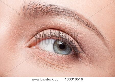 Closeup of eye of model woman looking away. Skincare concept. Cosmetics concept. Pretty lady posing for fashion or vogue magazine.