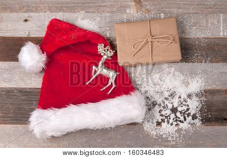 Christmas decoration Santa Claus hat and gift box on wooden background