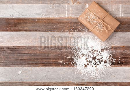 Christmas decoration gift box and snowflake on wooden background