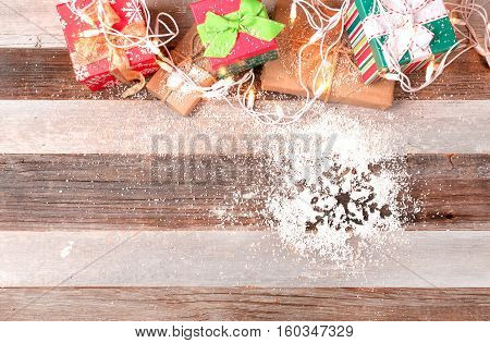 Christmas background with gift boxes on wooden board