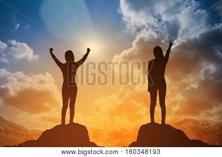 Silhouette Of Winning Success Woman At Sunset Or Sunrise Standing And Raising Up Her Hand In Celebra