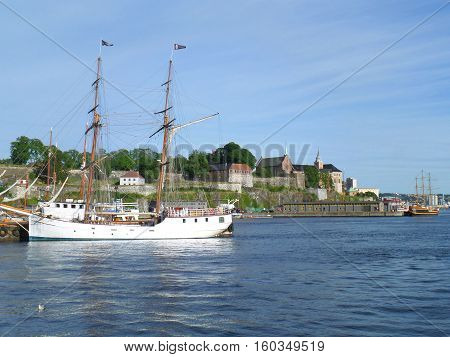 White sailing ship against Akershus Fortress, Olso Harbor, Norway