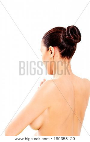 Back view of woman in towel sitting on the floor