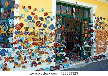 MARGARITES, CRETE - SEPTEMBER 15, 2016 - Pottery displayed on the wall of a shop in the village centre Margarites Crete Greece Europe, September 15, 2016.