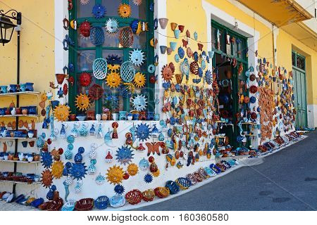 MARGARITES, CRETE - SEPTEMBER 15, 2016 - Pottery displayed on the wall of a shop in the village centre Margarites Crete Greece Europe, September 15, 2016.