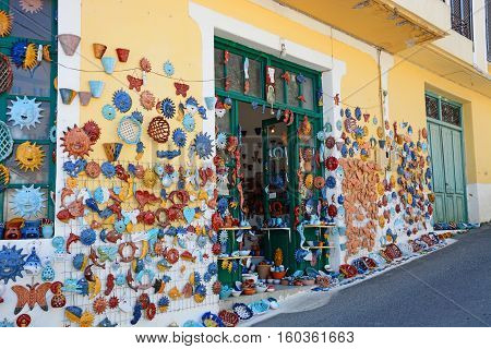 MARGARITES, CRETE - SEPTEMBER 15, 2016 - Pottery displayed on the wall of a shop in the village centre Margarites Crete Greece Europe, September 15, 2016.