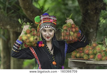 Tribal girl was picking rambutan fruither sale rambutan.