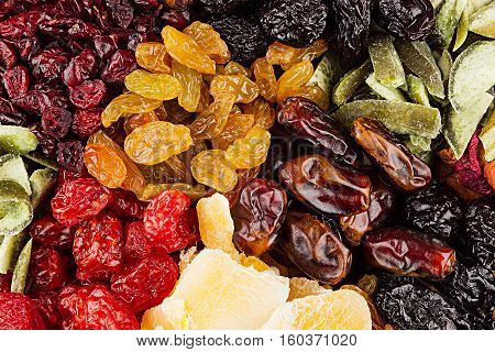Assortment of dried fruits closeup background in square cells. Decorative pattern of dry exotic fruit. Top view.