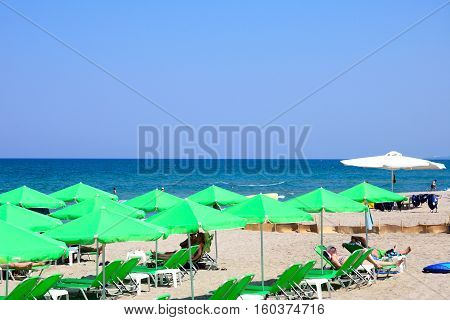 PERIVOLIA, CRETE - SEPTEMBER 15, 2016 - Tourists relaxing on the sandy beach Perivolia Crete Greece Europe, September 15, 2016.