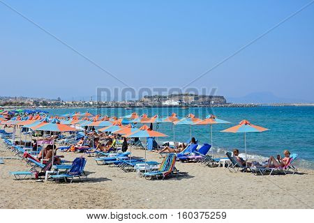 PERIVOLIA, CRETE - SEPTEMBER 15, 2016 - Tourists relaxing on the sandy beach Perivolia Crete Greece Europe, September 15, 2016.