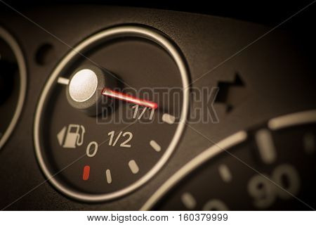 Color close up image of a car's fuel gauge.