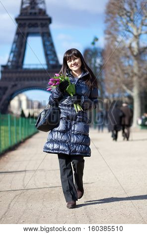 Cheerful Young Lady Walking By The Eiffel Tower