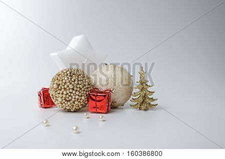 Gold and white xmas ornaments on white background. Merry christmas card. Winter holidays theme. Happy New Year. Space for text.