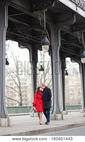 Romantic Couple Kissing On The Bir-hakeim Bridge In Paris