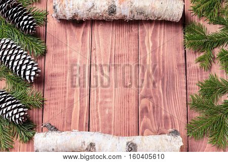 Christmas New Year composition with tangerines, cones, nuts, wicker basket and fir branches in rustic style on old wooden background, selective focus, Background new year, fir, gift, cones, orange, blue ball, red background