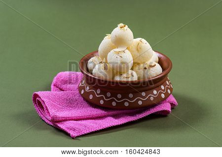 Indian Sweet - Rasgulla, Famous Bengali sweet in clay bowl with napkin