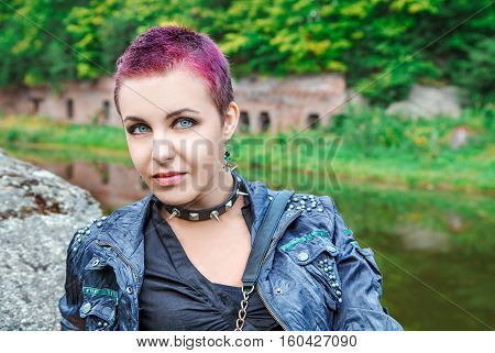 portrait of young beautiful punk girl with metal spiked collar